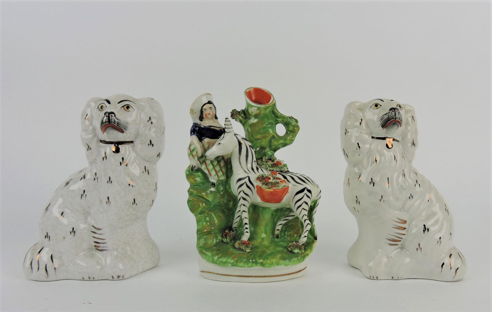 Staffordshire girl with zebra vase and: pair of dogs, 6 1/2"