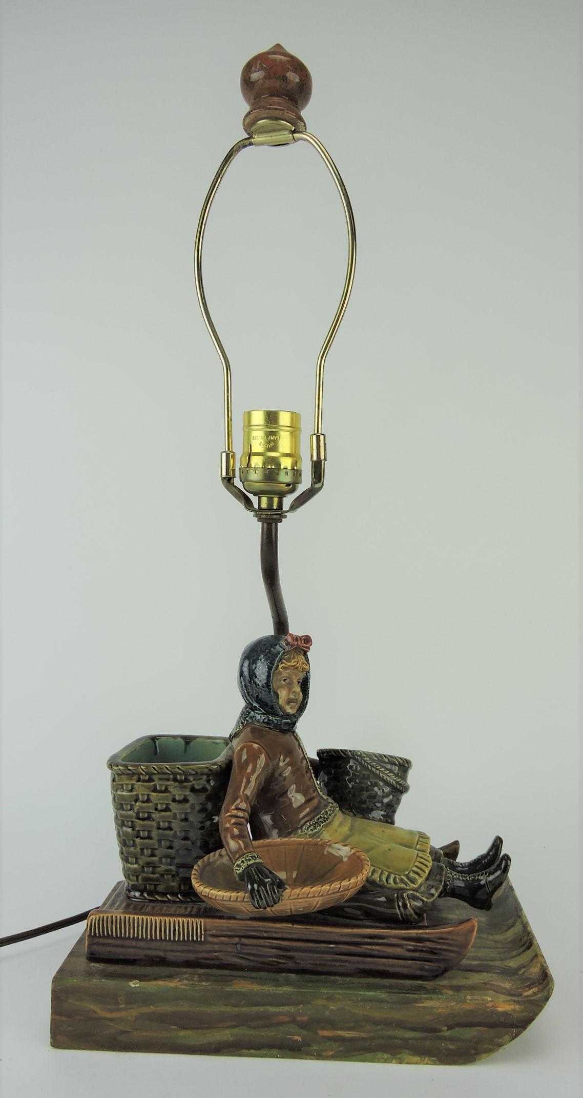 Majolica girl on sled match striker: made into lamp
