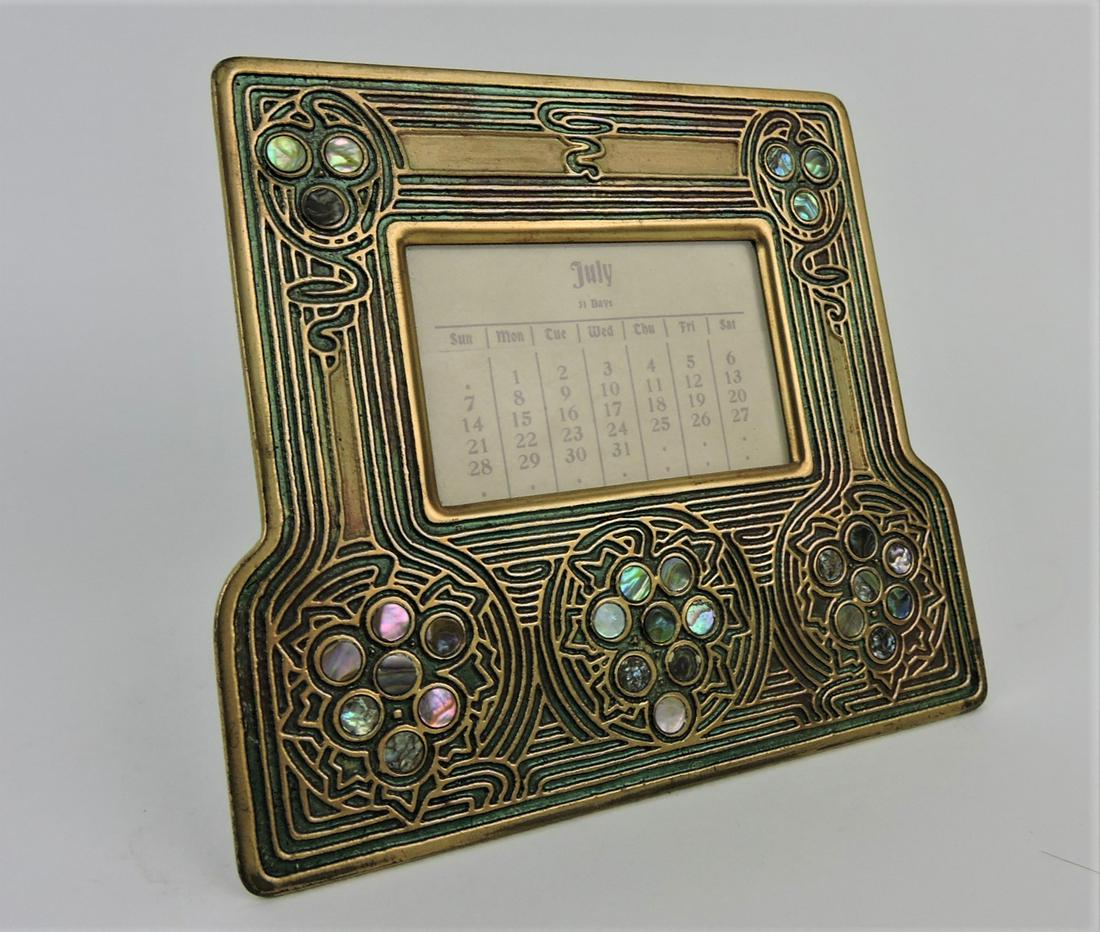 Tiffany Studios, New York, gilt bronze: desk calendar #1166 with abalone accent, 6 1/2"w, 5 3/4"h, a complete set of calendar inserts are included