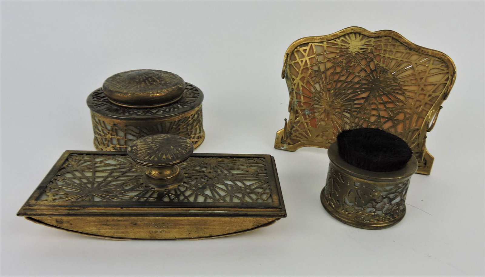 Tiffany Studios, New York, gilt bronze: 4 piece desk set - inkwell rocker blotter, pen holder, and stamp moistener