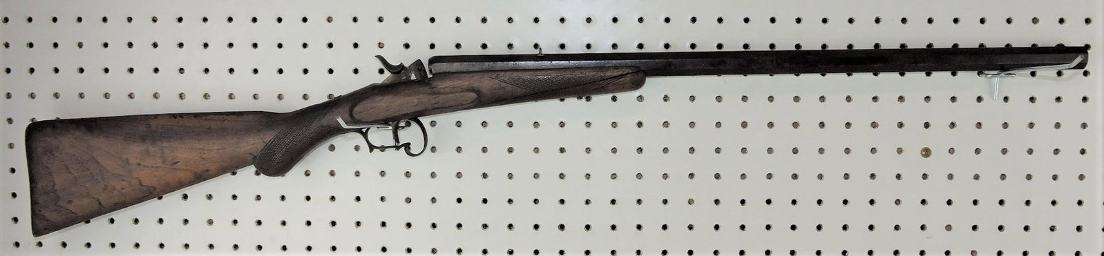 Black powder .22 caliber rifle with: heavy octagon barrel, stock cracked, 40"