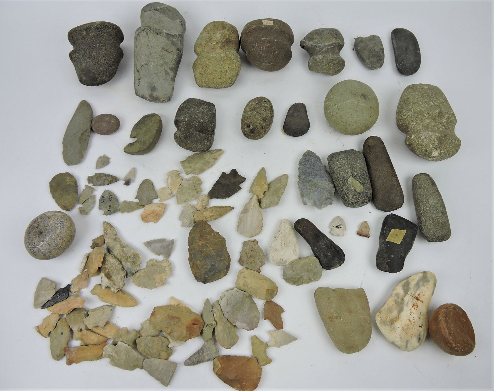 Lot of assorted Indian relics, arrowheads,: flint, celts, axes, and more