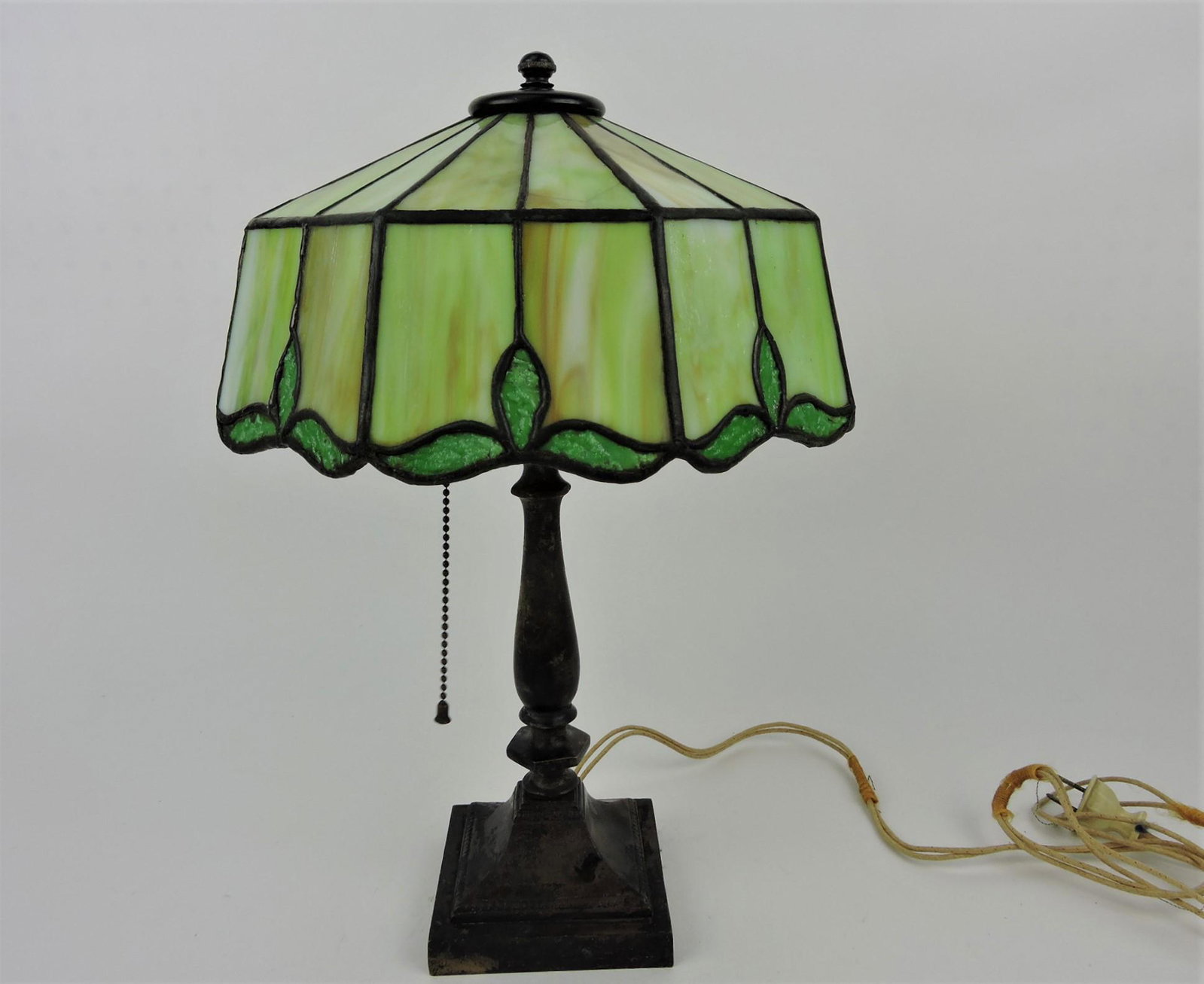Leaded glass bedroom lamp with: bronze base, shade marked Tiffany Studios, 16"h, 10"w, one piece of glass cracked