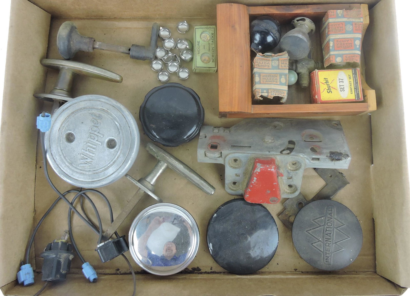 Box of auto parts, door handles, caps,: and more