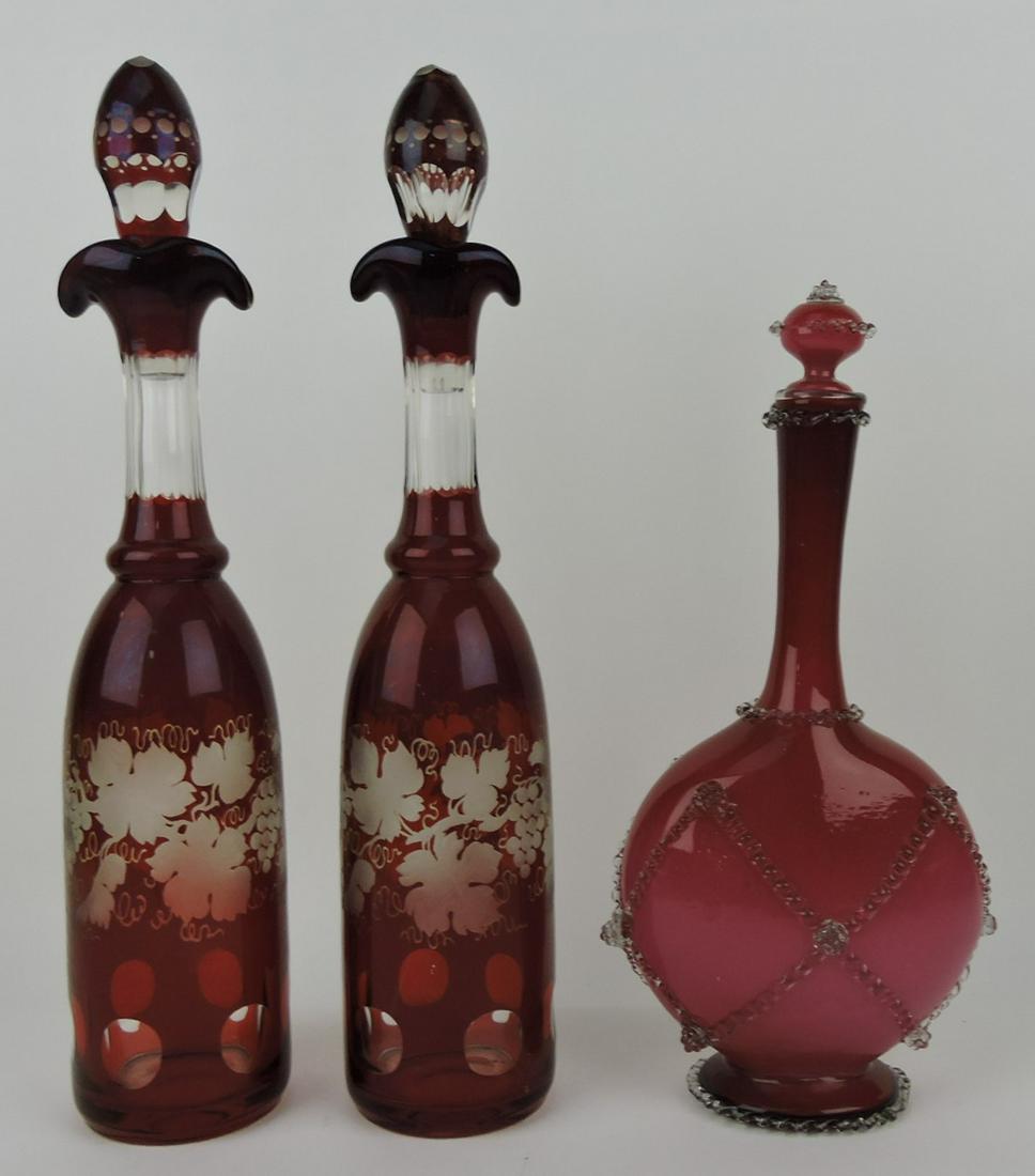 Bohemian ruby cut to clear pair of: wine decanters, 16 1/2", and Stevens & Williams wine decanter, some losses, 13"