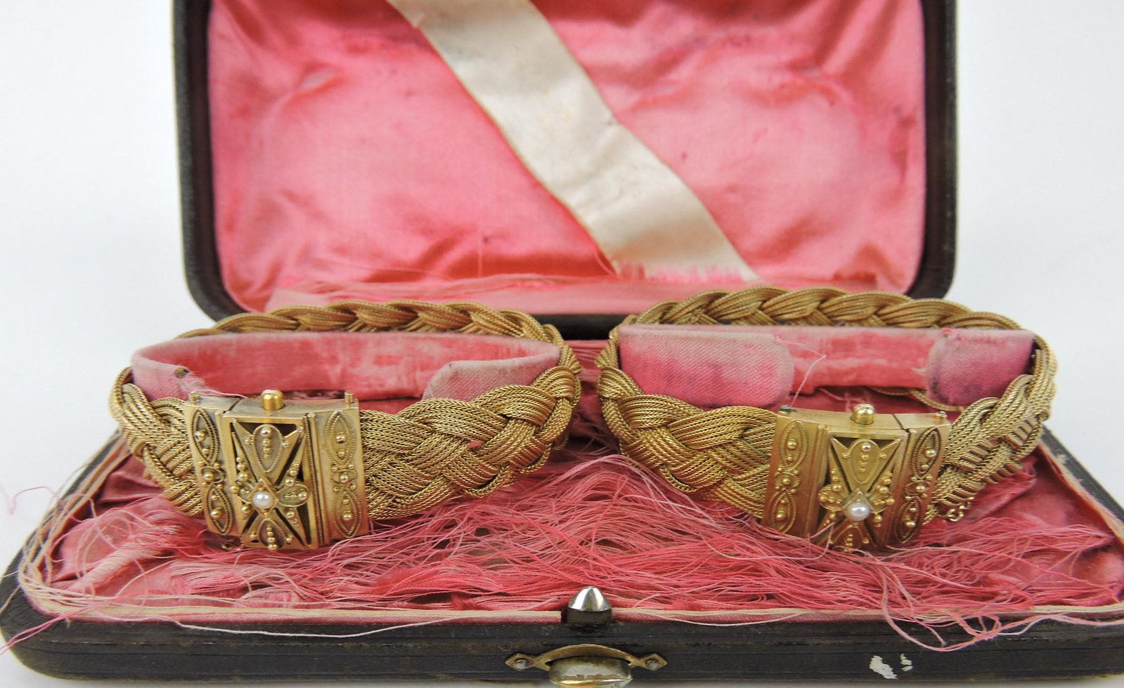 Pair of Victorian 14kt yg wedding bracelets: in original box, each with a center mounted pearl, inscribed and dated on back 1883, 71.7g