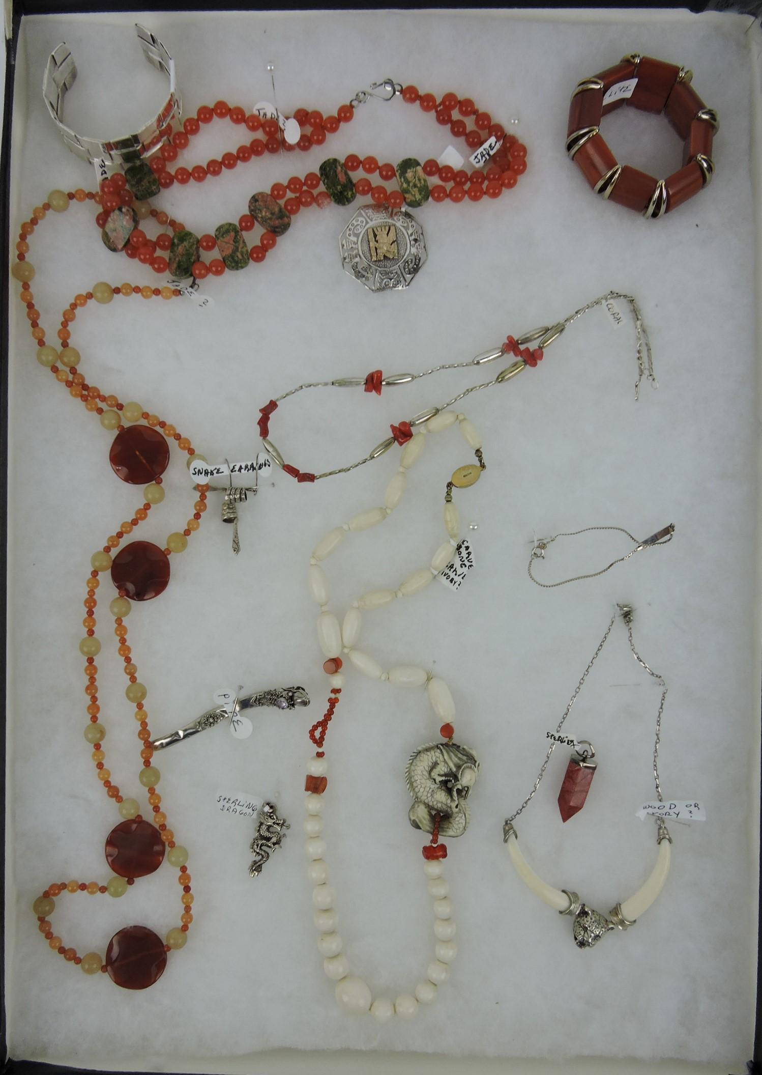 Jewelry tray of jade, sterling, and bone -: necklaces, bracelets, Bakelite, dragon pipe, pendant, and more