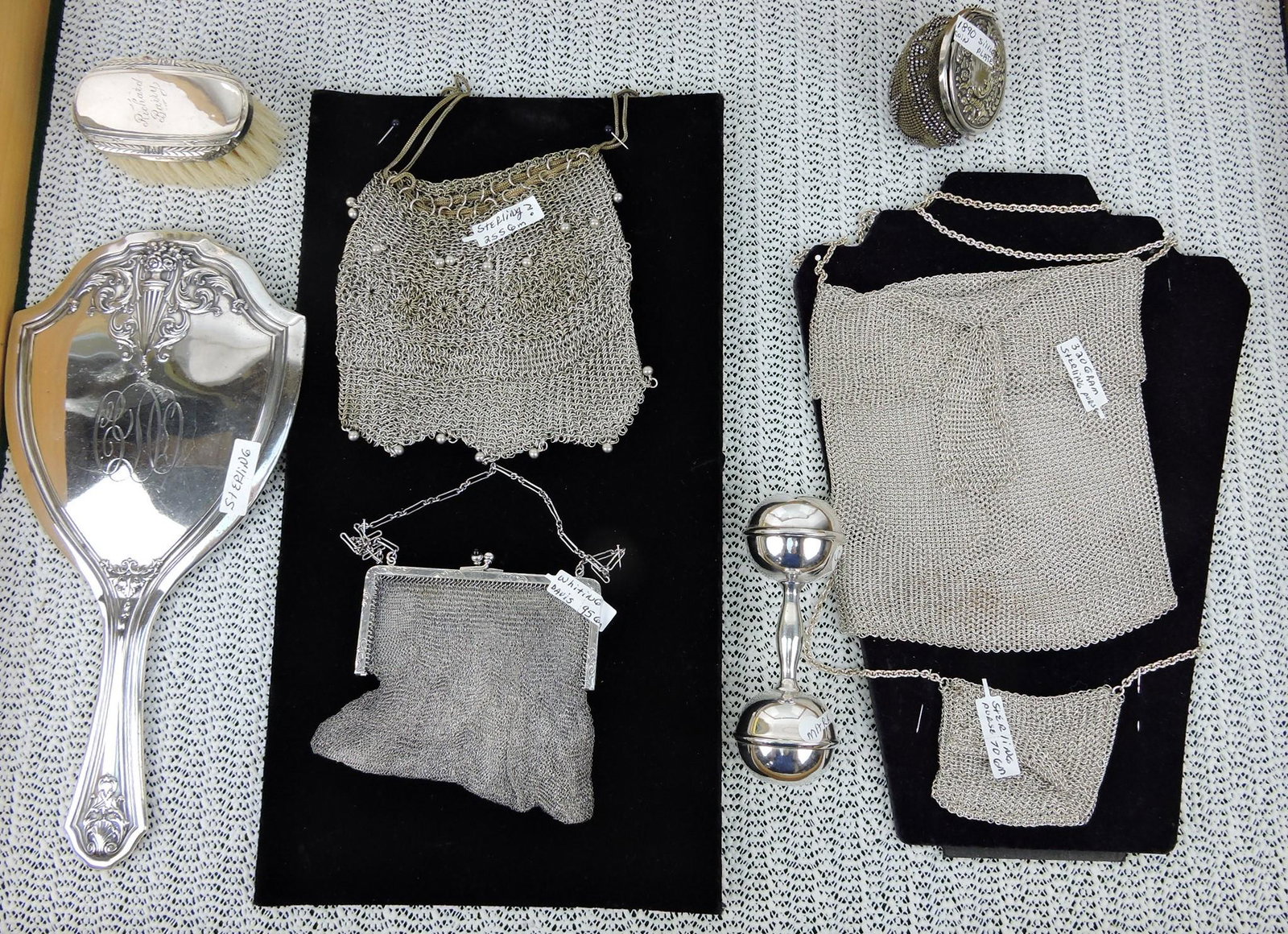 Sterling silver lot - 4 purses, hand mirror,: brush, rattle, silver plate coin purse, 840g+