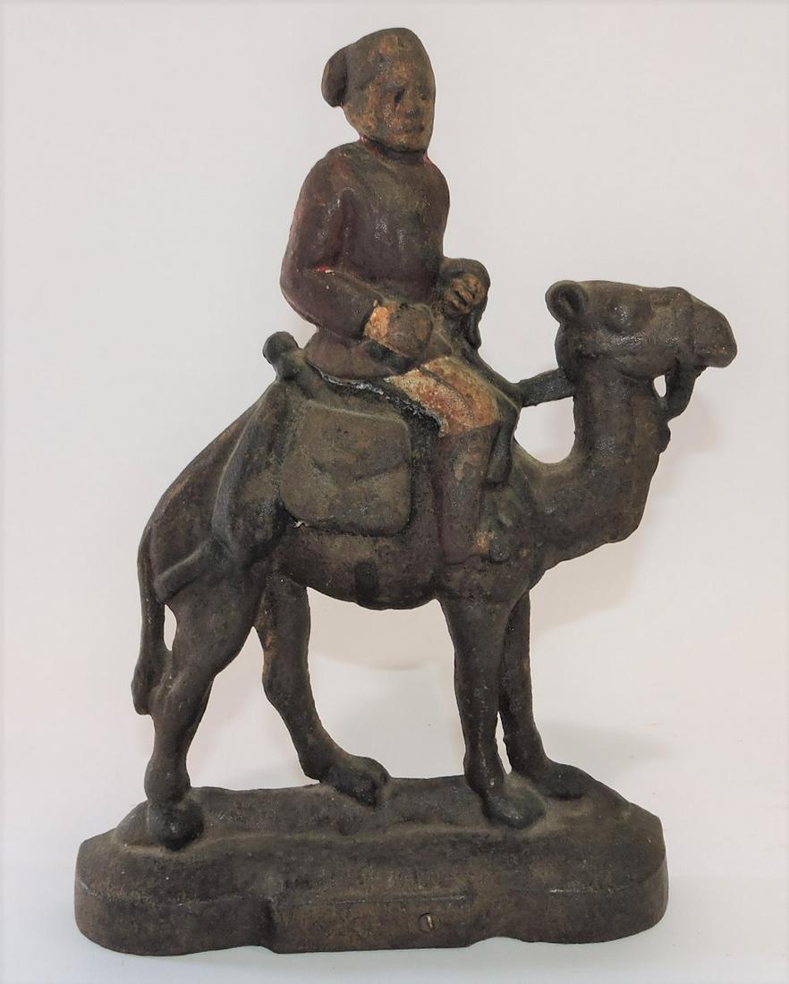 Cast iron man on camel door stop, (1 of 1)