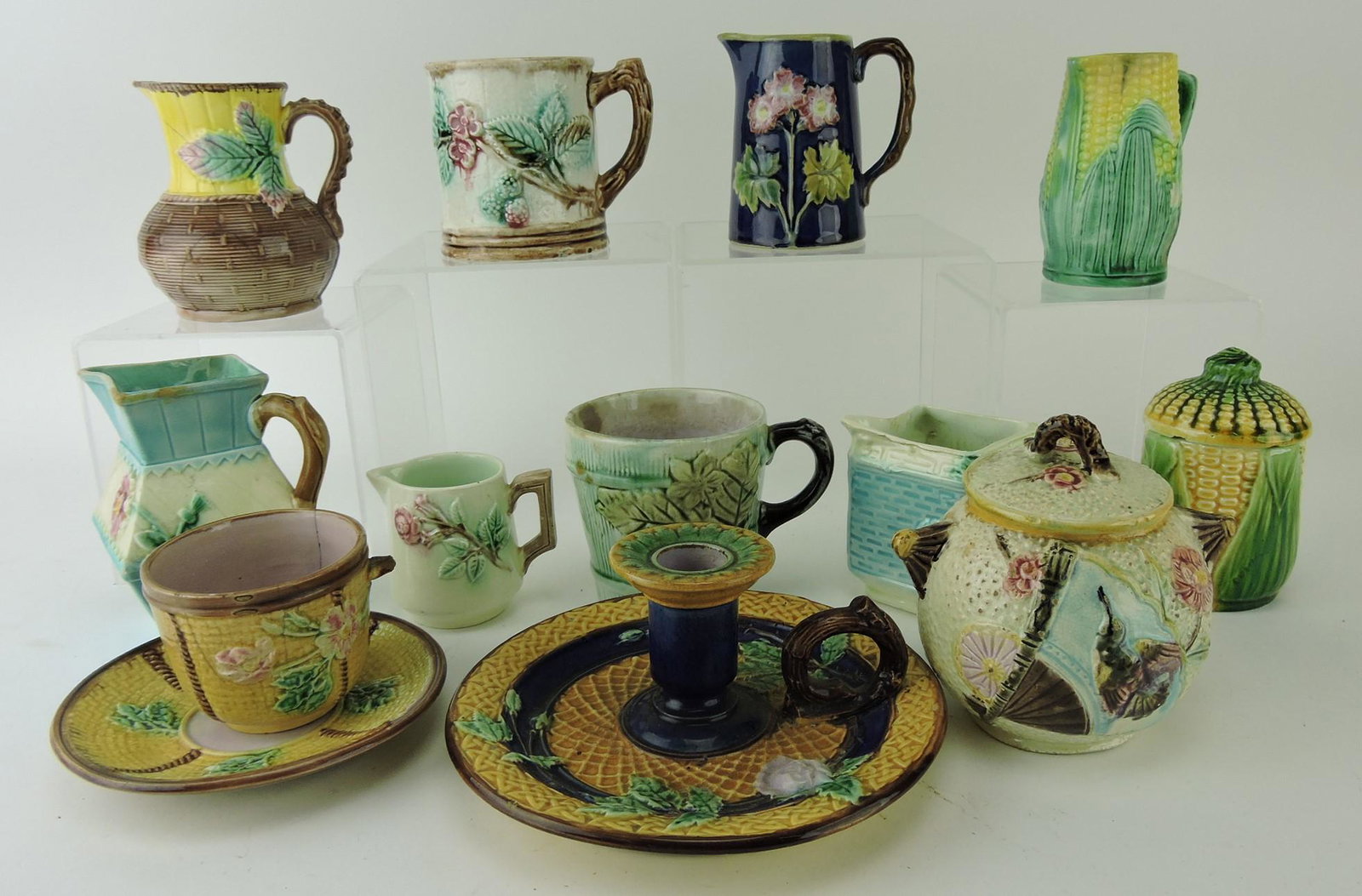 Majolica lot of 12 creamers, sugar,: candle holder, corn jar, mugs, cup/saucer, various condition