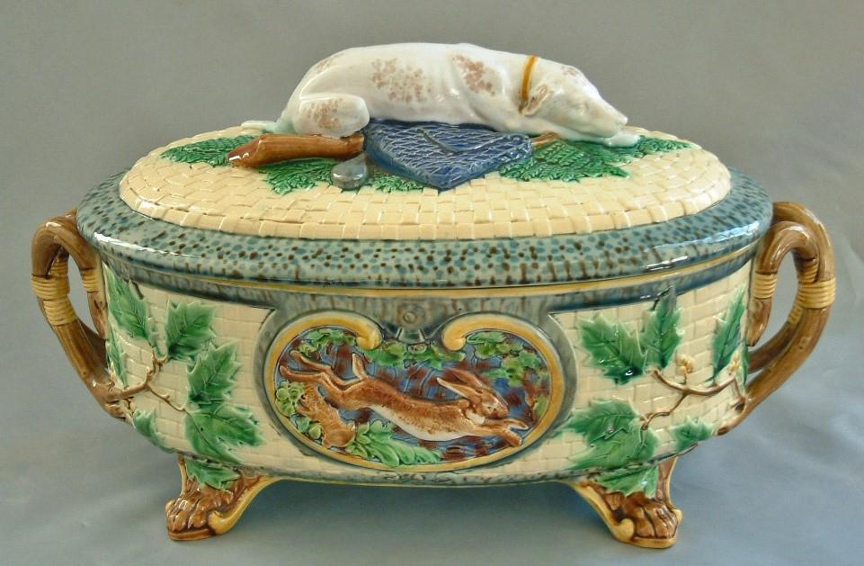 Minton majolica gun dog tureen on: four paw feet with pheasant and running hare panels, holly leaves to sides, impressed Minton, shape no. 864, 14 1/2"w