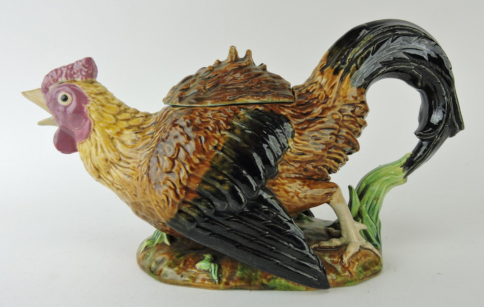 George Jones majolica running rooster: figural teapot, 11"l, professional repair to lid and beak