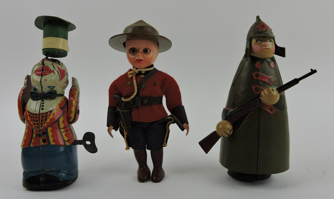Japan tin wind-up clown, Celluloid: Canadian Mountie, walking solder with gun