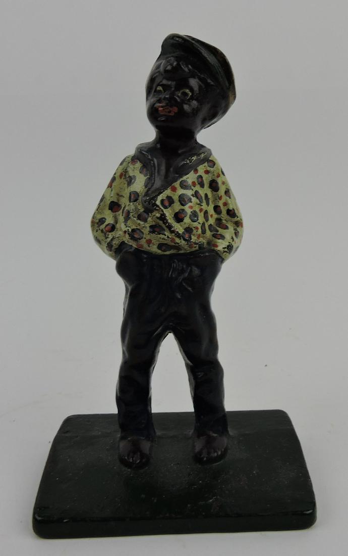 Cast iron door stop of a black boy: with hands in pockets, 7"