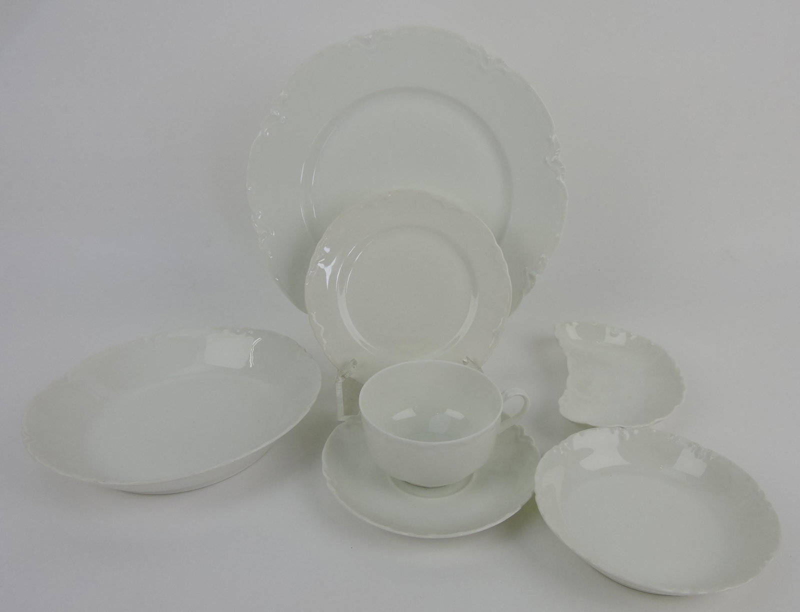 Haviland set of white china: 16 - 9 1/2",: 17 - 6" plates, 14 - 5" fruit bowls, 6 - 7 1/4" flat soup bowls, 12 bone dishes, 10 cups, 16 saucers, vegetable tureen, creamer, jelly pot, 12 12" round platter, sauce boat, 6 assorted serving dishes,