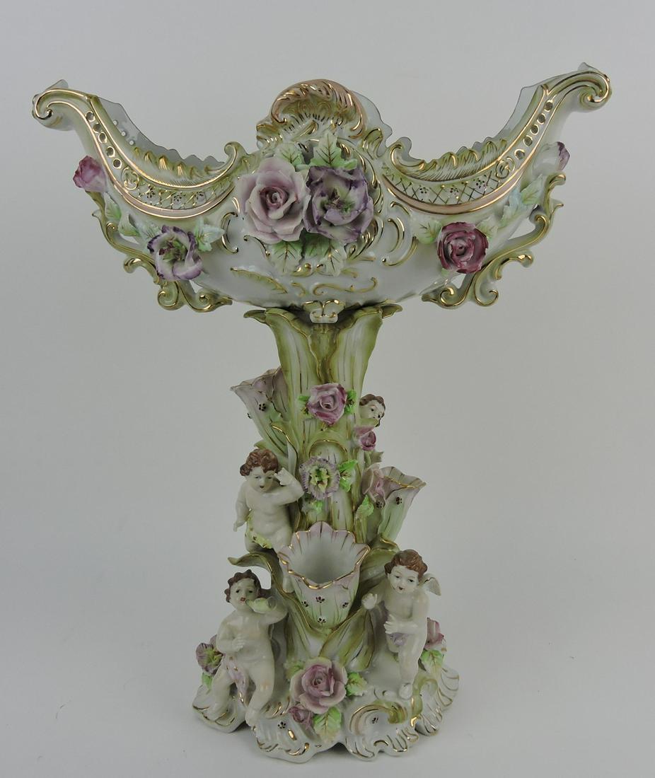 Porcelain table center with cherubs, 16 1/2": .