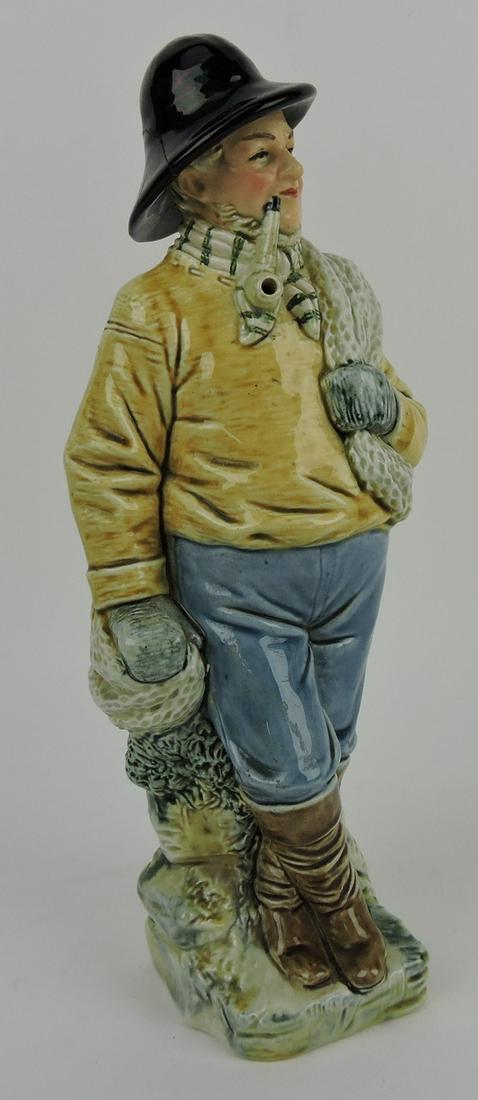 Gesetzl Gesch majolica fisherman: figural decanter, repair to hat