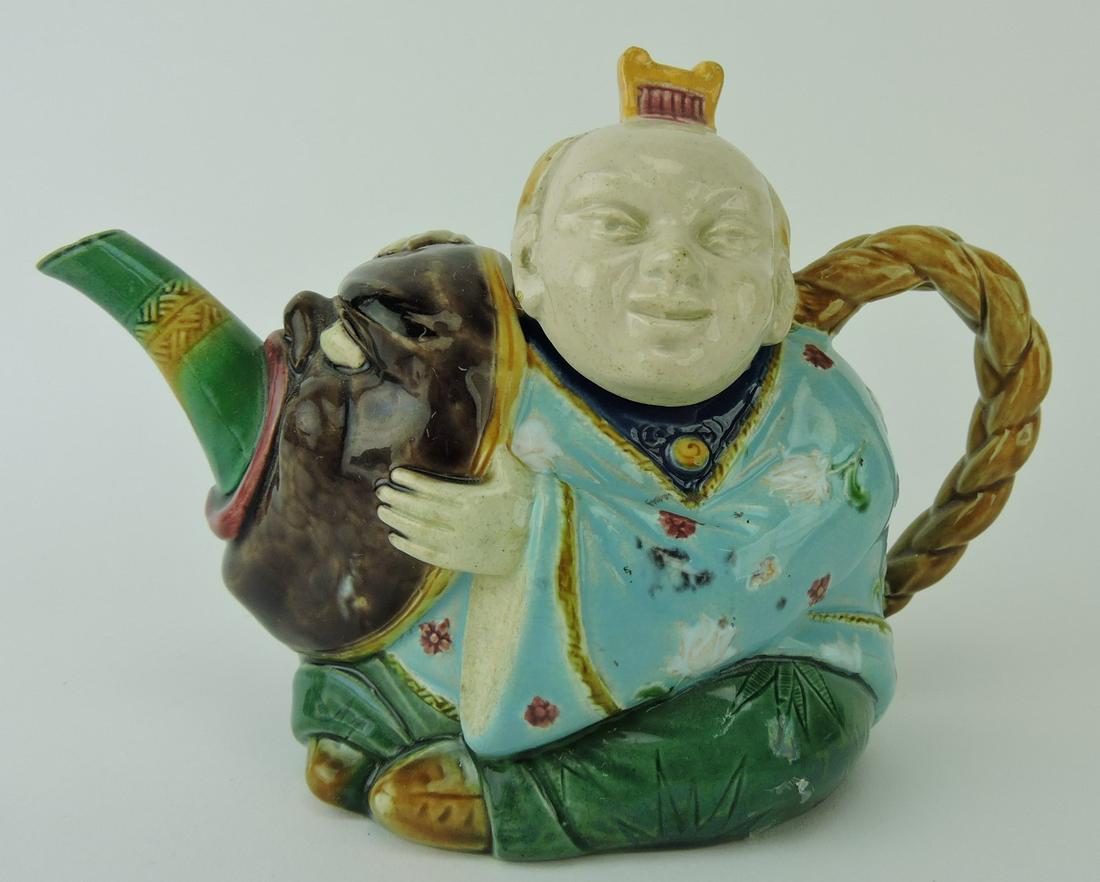 Minton majolica Chinaman teapot with: Chinaman holding mask and braided ponytail forming handle, 7 1/2"l, 5 1/2"h; Ann and Robert Fromer Collection