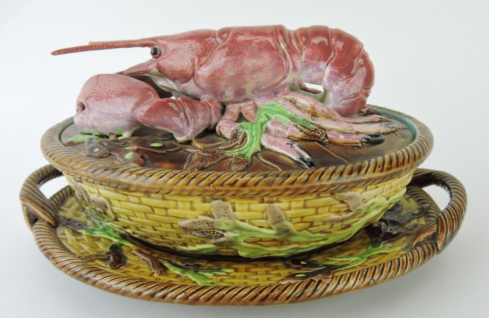 George Jones rare majolica pate box: on stand modeled as a basket with coral, the base with twin rope handles and the cover modeled as a large lobster on a bed of seaweed, rare to have lobster's tentacles (restored), professional repair 