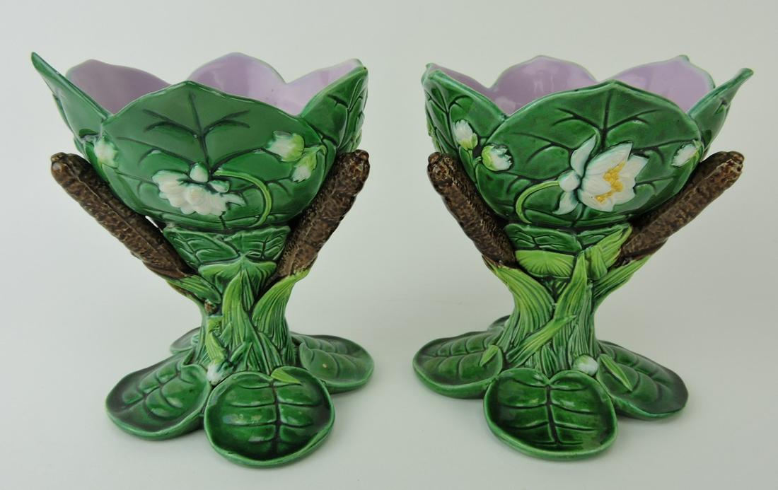 George Jones majolica pair of lily and: cattail posy vases modeled as green lily pads forming bowl with pink interior supported by cattail pedestal and four lily pad feet, 5 3/4", professional rim repair to one; Ann & Robert Fromer Collecti