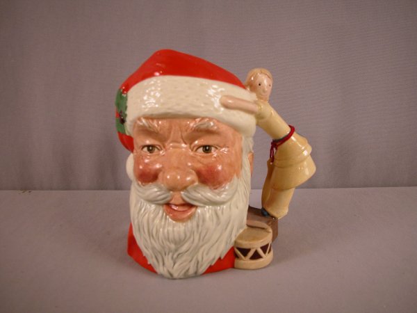 Royal Doulton character jug, "Santa Claus" with do: Royal Doulton character jug, "Santa Claus" with doll and drum handle, 7 1/2", D6668