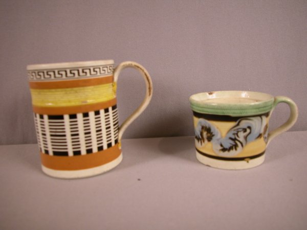 2 Mocha ware mugs one with geometric design and o: 2 Mocha ware mugs one with geometric design and one with earth worm, both with damage