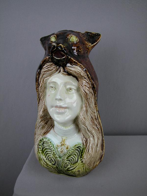 FRIE ONNAING figural pitcher of French woman wear: FRIE ONNAING figural pitcher of French woman wearing the skin of a bear, 9 1/2", rare form, ref: Cunningham p. 110