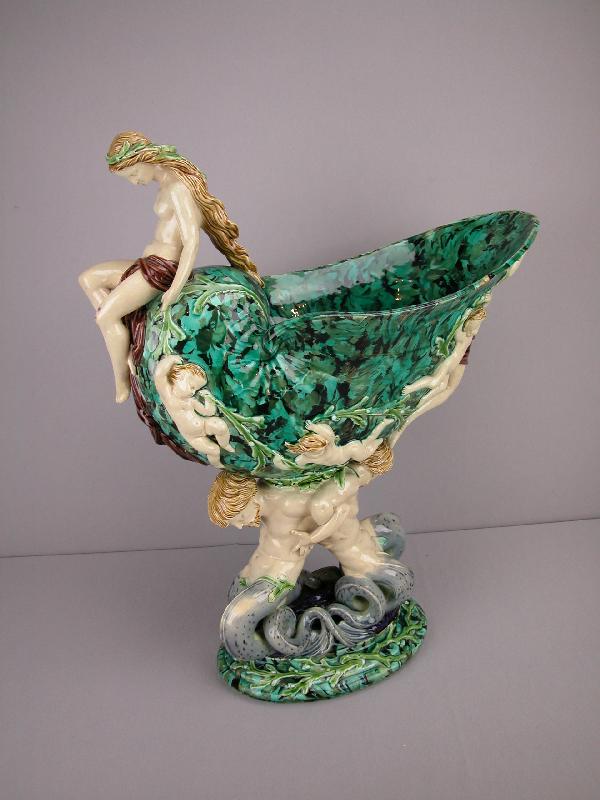 MINTON figural nautilus shell table center with m: MINTON figural nautilus shell table center with maiden atop shell surrounded with puttis in high relief supported by two mermen, very rare malachite ground, outstanding color and detail, shape no 992,