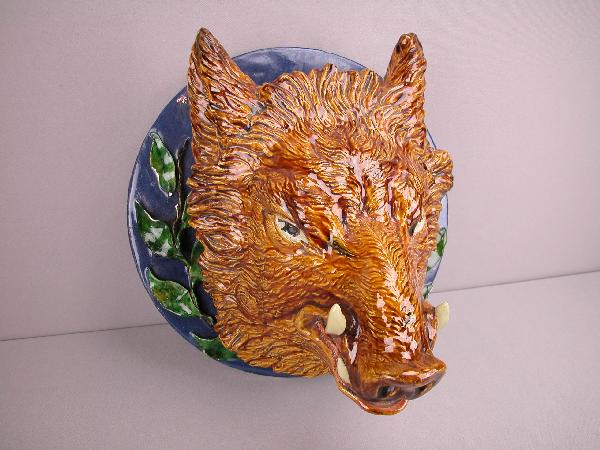 Monumental majolica boars head wall plaque on c: Monumental Pinheiro French majolica boars head wall plaque on cobalt base, great detail, chips and repair to leaves on base, professional repair to tusks and ear tip, 11" deep, 14" diameter,