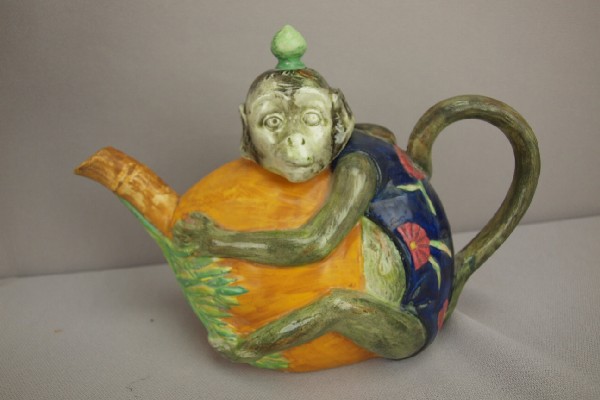French Creil figural teapot in the form of a mon: French Creil figural teapot in the form of a monkey grasping a coconut, 8 1/2"l