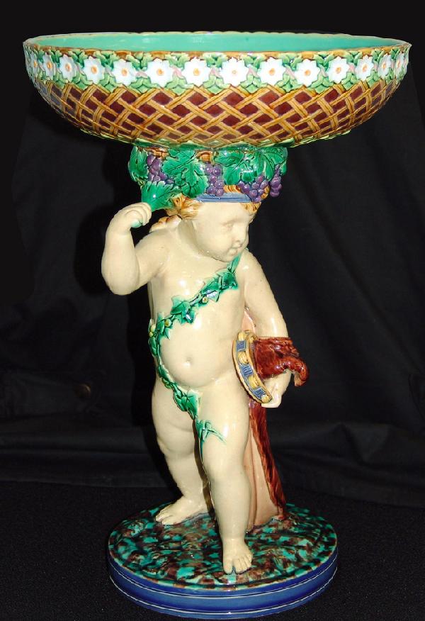 MINTON rare majolica cherub and daisy head cente: MINTON rare majolica cherub and daisy head centerpiece designed by Albert Carrier Bellouse, 15"h