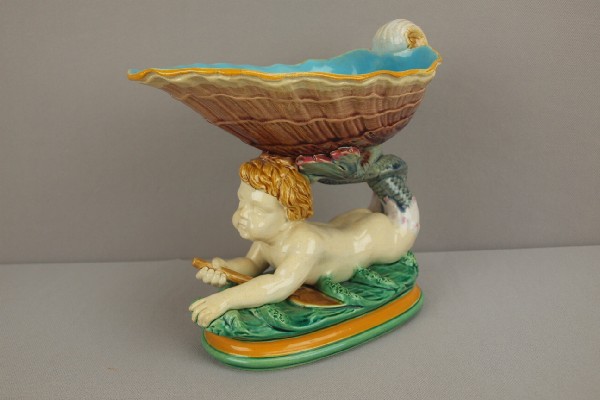MINTON majolica figural sweet meat dish with shel: MINTON majolica figural sweet meat dish with shell supported by merman on wave, 8"h, minor hairline to shell