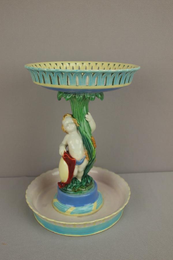 ROYAL WORCESTER rare from comport with reticula: ROYAL WORCESTER rare from comport with reticulated bowl supported by putti with cattails and shield, 8 3/4"h