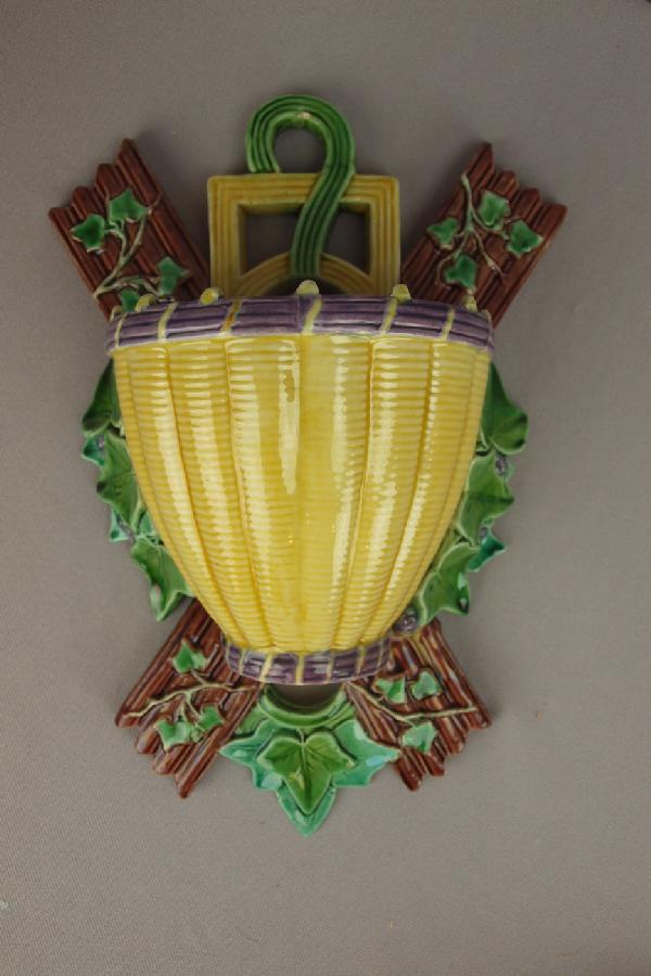 MINTON majolica wall pocket in the form of a bas: MINTON majolica wall pocket in the form of a basket surrounded by grapes and vine on a picket fence, shape no. 1690, 11"l, professional rim repair to basket