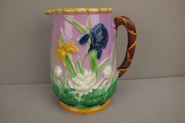 GEORGE JONES majolica iris and water lily pitche: GEORGE JONES majolica iris and water lily pitcher with pink ground, great color, 8", professional hairline repair