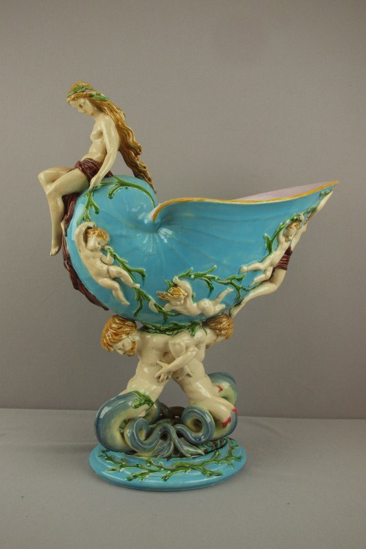 MINTON majolica figural nautilus shell table cent: MINTON majolica figural nautilus shell table center with maiden atop shell surrounded with puttis in relief supported by two mermen with turquoise ground, shape no. 992, 21"h, 18"w, professional repai