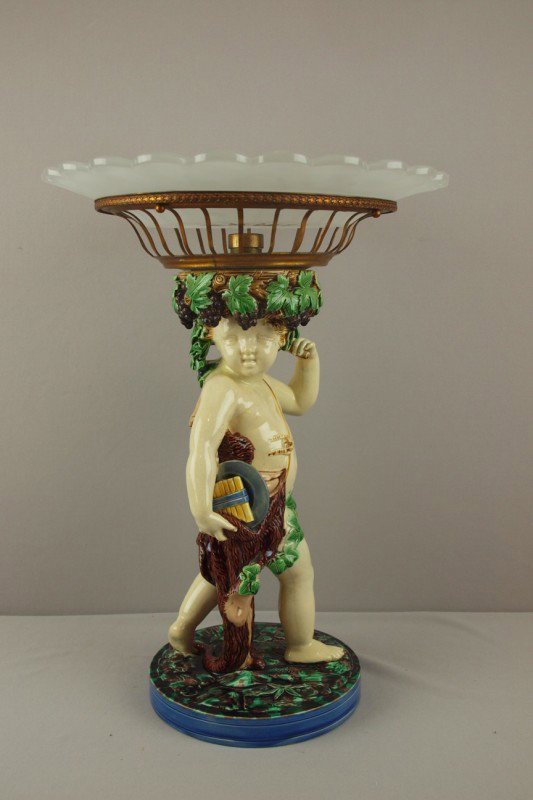 MINTON majolica table center in the form of a hun: MINTON majolica table center in the form of a hunter holding a brass basket on head with a glass insert, shape no. 1873, professional repair to arm and neck of hunter, 19"h
