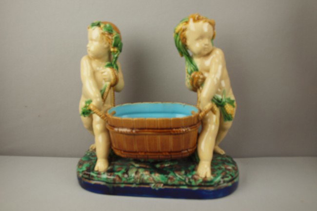 MINTON majolica table center in the form of two v: MINTON majolica table center in the form of two vintagers carrying tub, 11"h, 11 1/2"w
