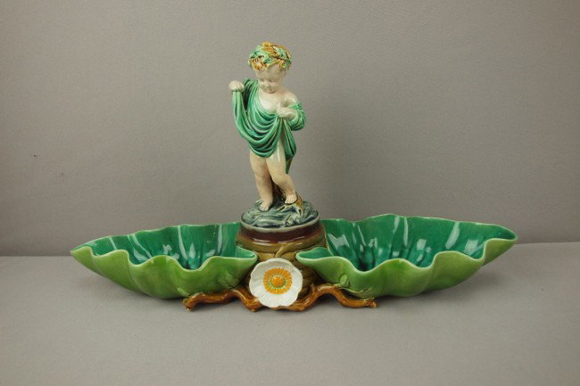 MINTON majolica two part server with putti between: MINTON majolica two part server with putti between two large leaves, 15"l, 7 3/4"h, shape no. 1566