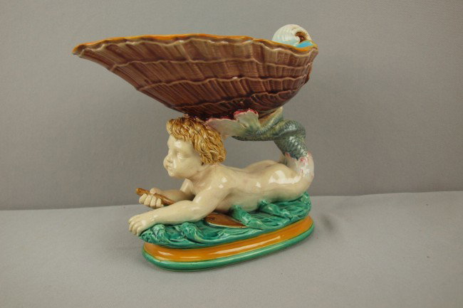 MINTON majolica sweet meat dish in the form of a : MINTON majolica sweet meat dish in the form of a merman on waves supporting shell, professional rim repair, 8 1/2"l, 7 1/2"h