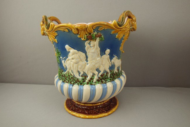 MINTON majolica Campaniform wine cooler with a gro: MINTON majolica Campaniform wine cooler with a group of Bacchanalian figures on each side and goat's head handles on periwinkle/gray ground, 10"h