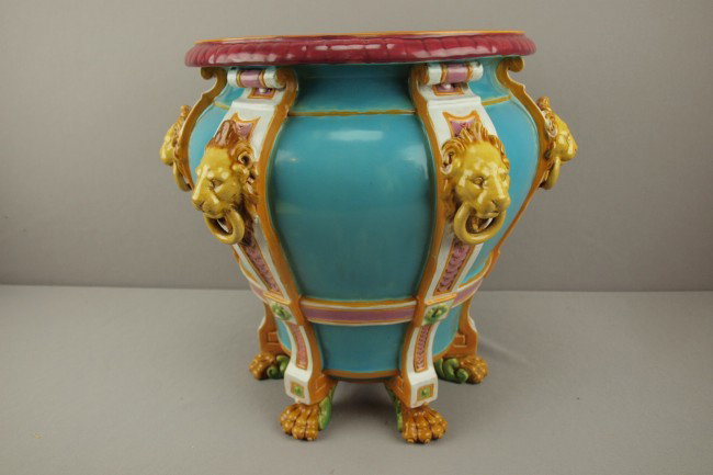 MINTON turquoise majolica jardiniere with lion mas: MINTON turquoise majolica jardiniere with lion mask and ring handles and paw feet, 14"h, 16"w, professional rim repair
