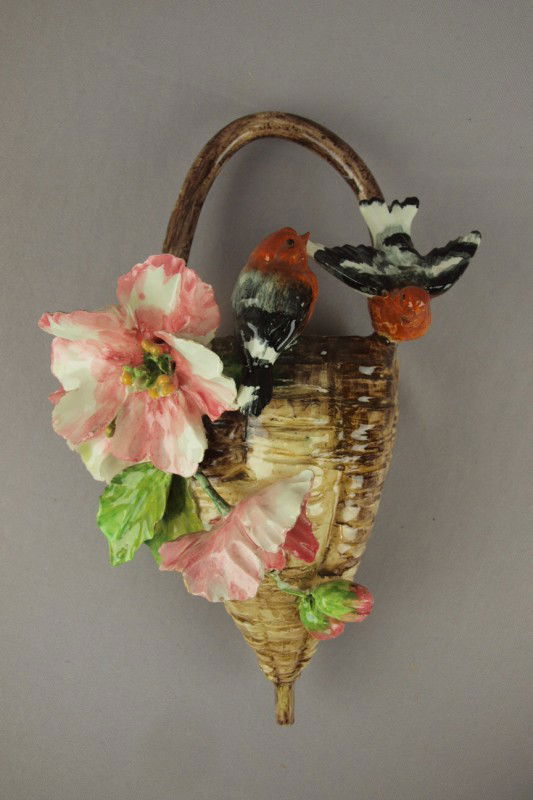 French majolica wall pocket in the form of a baske: French majolica wall pocket in the form of a basket with two birds ad applied flowers, minor nicks to high points, 12"h