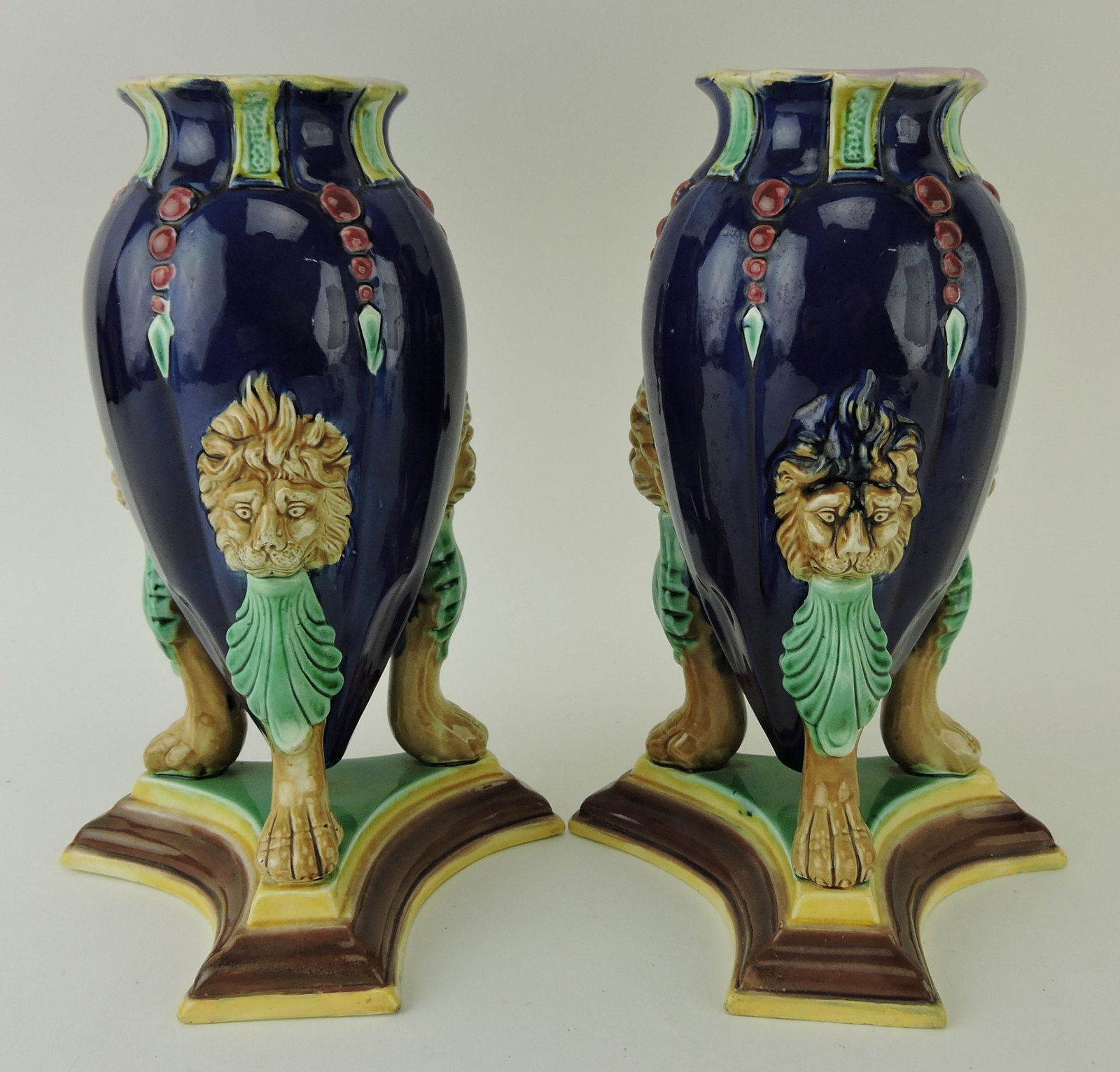 Majolica pair of amphora vases with lion: masks and paw feet on trefoil base, 9 1/2", minor hairline to one