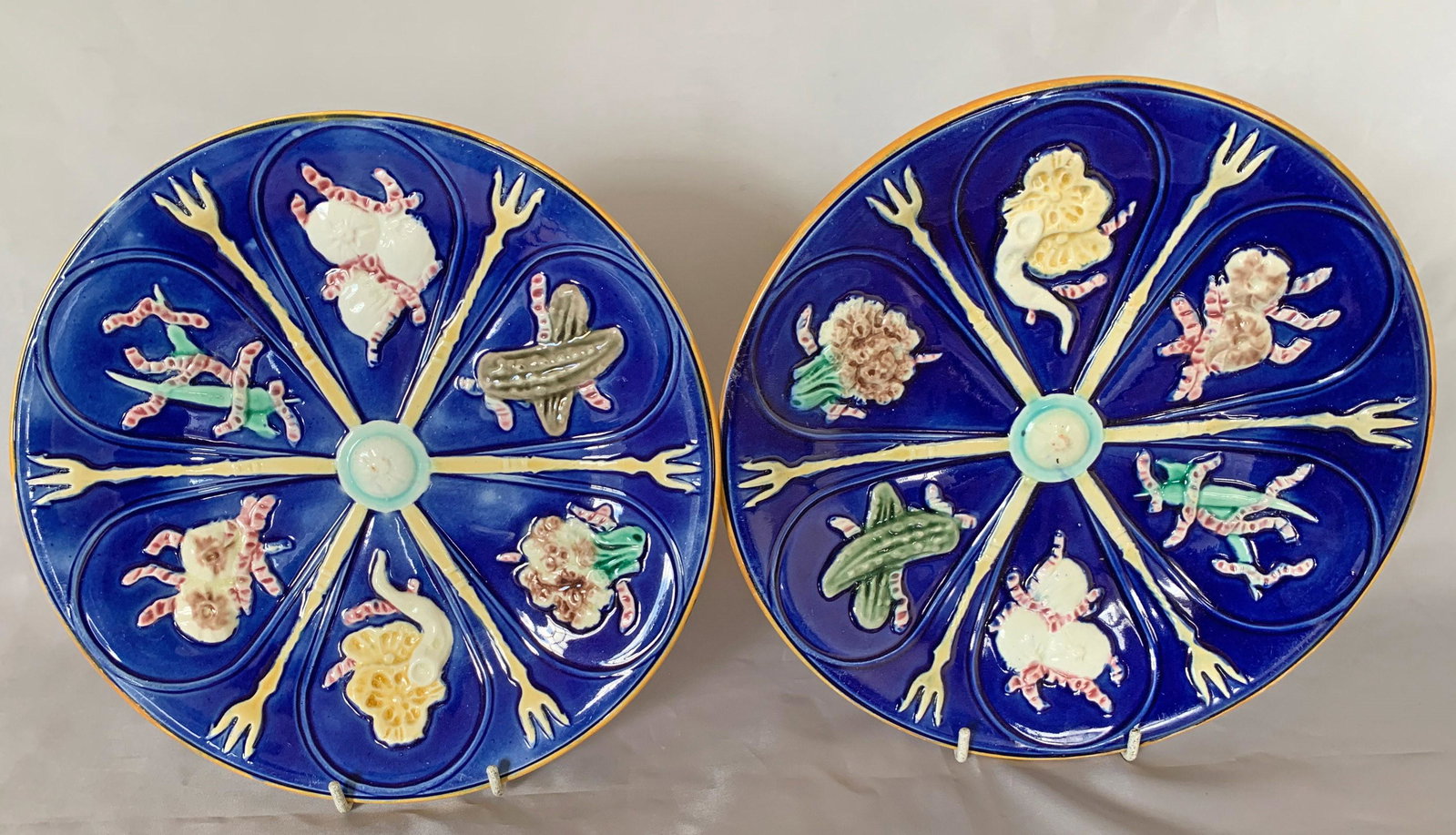 A pair of Wedgwood majolica pickle: plates, molded with pickle forks and cobalt ground, 8 1/4"