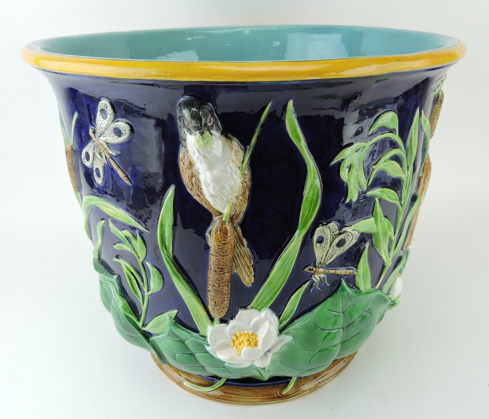 George Jones cobalt majolica lily pad,: blossoms cattails, bird, and dragonfly large jardiniere, 16 1/2"d, 15"h, professional hairline repair; matches lot 3400