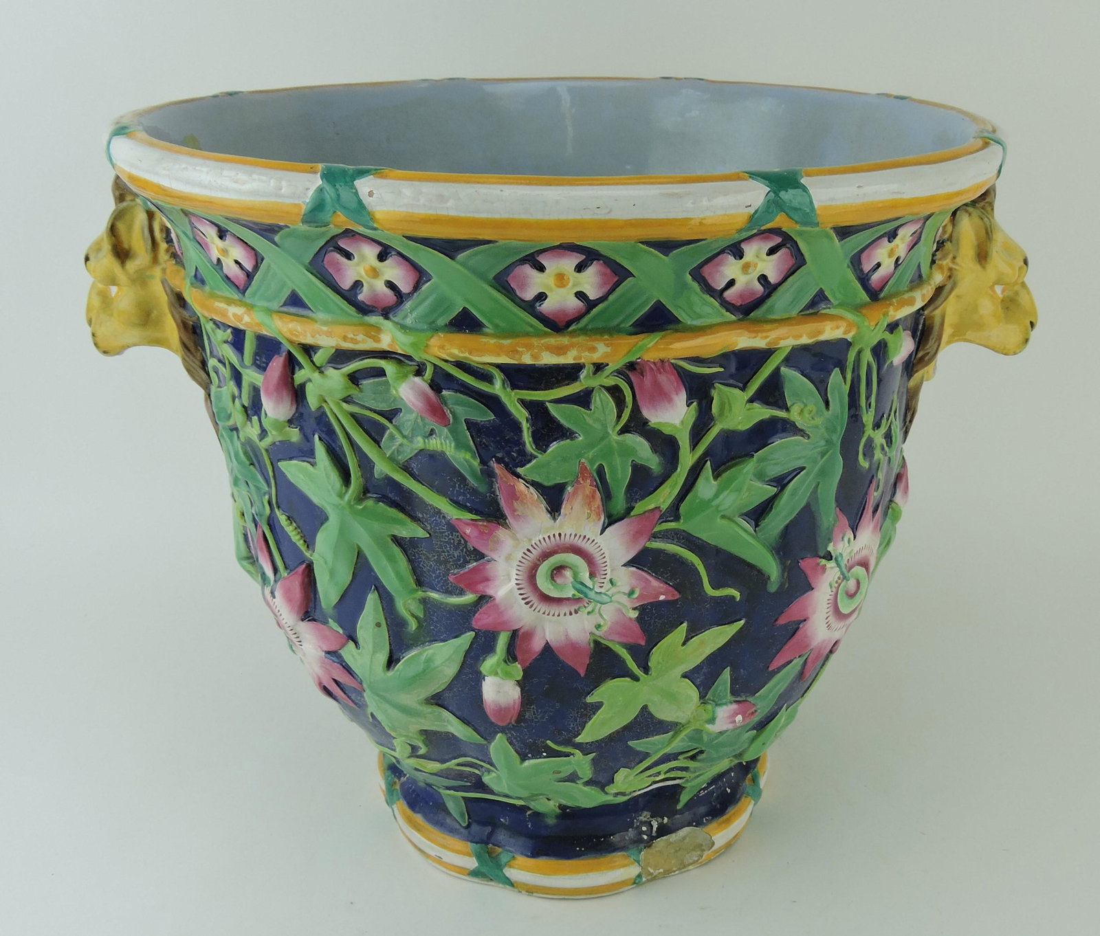 Minton majolica cobalt passion: flower jardiniere with lion mask handles, old repairs, chip to base, 13 1/2"h, 18"w