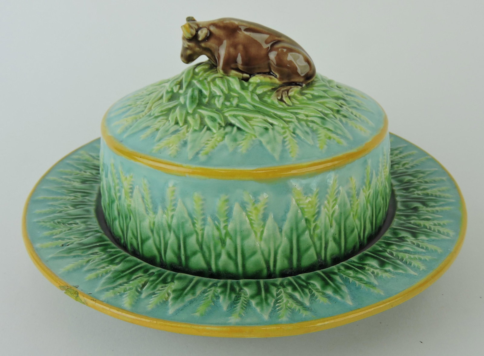 George Jones majolica wheat: butter dish with cow finial, rim chip to base and cow's horns