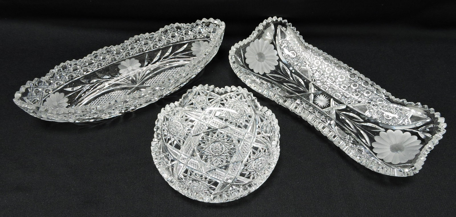 American Brilliant cut glass lot of: 3 pieces: 12 1/2" celery boat, cane pattern and floral etching (nick); 12 1/2" x 5 1/2" relish tray, hobstars, cane, and etched flowers (nick); 7 1/4" heavy deep cut hobstars nappy (nick)