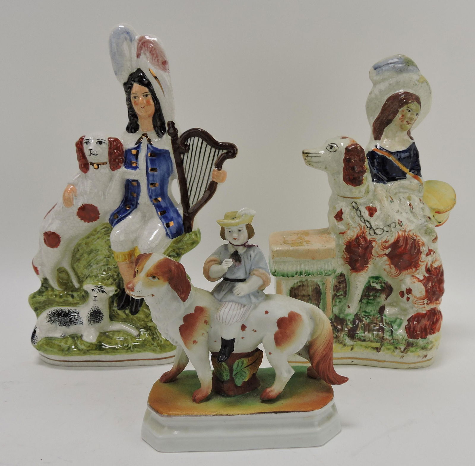 Lot of 2 Staffordshire and one bisque: figures with dogs, 5 1/2 to 10"